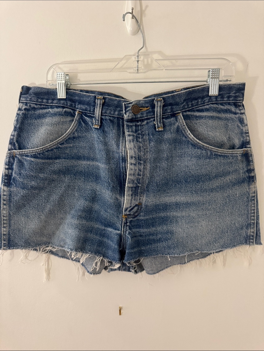 High-Rise Distressed Denim Shorts in Medium Blue